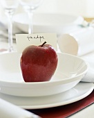 Christmas place-setting with red apple and place card