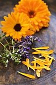 Marigolds, lavender and thyme in a wooden bowl
