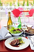 Pork fillet with pea puree, salad, bread and wine