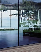 Details of a terrace with wooden floor boards, windows and a view of the landscape