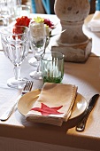 A place setting with a napkin and glasses