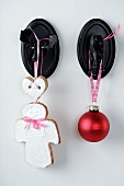 A shortbread angel and a Christmas bauble on a moose hook