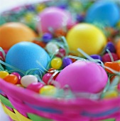 Easter eggs and sugar eggs in coloured basket
