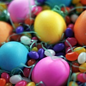 Coloured Easter eggs and sugar eggs in Easter nest
