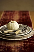 Small White Pumpkin on a Stacked Place Setting