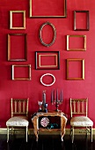 Assorted Frames on a Wall; Chairs and Table