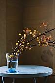 Crab Apple Branch in a Blue Vase on a Table