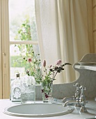 A washstand with a small bunch of flowers