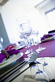 Wine glasses on a purple table runner, photo taken at an angle