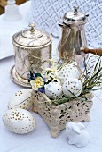 Easter decoration next to silver containers