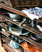 Old baking tins and pots on a wooden shelf