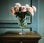 Salmon colored roses in a glass vase