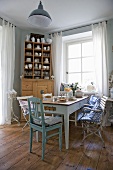 A dining room with a shabby-chic style dresser