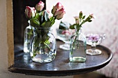 Rosen und Nelken in Glasvasen