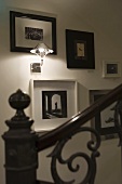Ambient wall lighting in a stairway with a collection of pictures on the wall