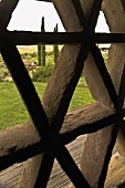 View through an open wooden lattice of a Mediterranean landscape