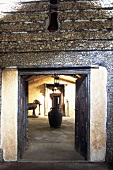View through a doorway of an African courtyard with an amphora and animal sculpture