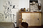 Schlafraum mit Kommode und schwarzweiss Zeichnungen an Wand