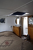 Cabin with a vanity and shower stall in a house boat
