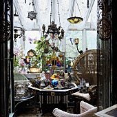 A romantic conservatory with antiques and small items of oriental furniture