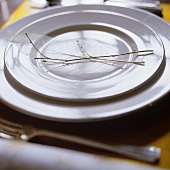 A place setting with white plates and decoration