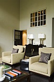 Natural coloured armchairs and small art deco-style furniture with overhead light