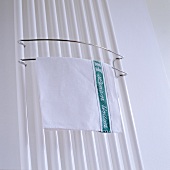 A tea towel on a towel rail on a radiator