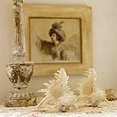 White seashells and a painting on the wall