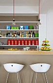 Breakfast at a bar - white stools in front of a bar and a shelf in the wall niche