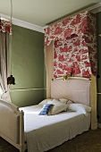 An upholstered bed with a canopy in a bedroom in a country house