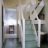 A staircase with a bathroom in the background - 19th century German thatched-roof house decorated in a Scandinavian style