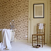 A bathroom in a country house with floral wallpaper