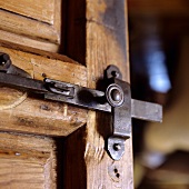 A wrought iron bar on a wooden door