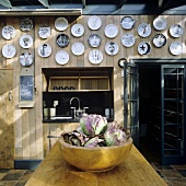 A collection of plates hanging on the wood panelling in a kitchen