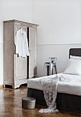 Bright gray wardrobe in the corner of a bedroom