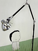 Adjustable floor lamp with chrome lampshade in front of a picture
