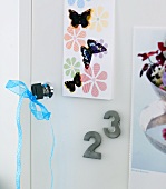 Door lock and key with blue ribbon and decorative butterflies on a cabinet