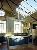 Central island unit in kitchen with industrial style pitch roof