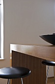 Stools with black seat at wooden breakfast bar
