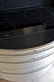 Ceramic hob above white fitted drawer unit