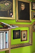 Collection of portrait paintings above book shelf