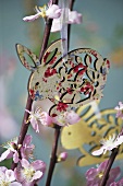 A wooden rabbit decoration hanging from flowering twigs