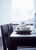 Monochrome table setting on black dining table