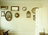 Collection of various mirrors displayed on wall
