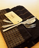 Eating utensils with label on a dish towel