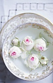 White roses in a bowl of water