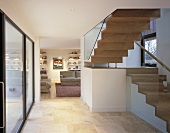 An open stairway with a view into an open-plan living room