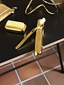 Various golden bath utensils (toothbrush, nail brush, etc)