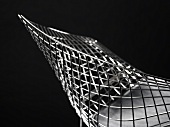 A diamond chair by Harry Bertoia - designer bucket chair made of metal