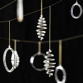 Christmas decorations hanging against a black background